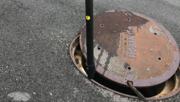 Repair work being done to a manhole cover