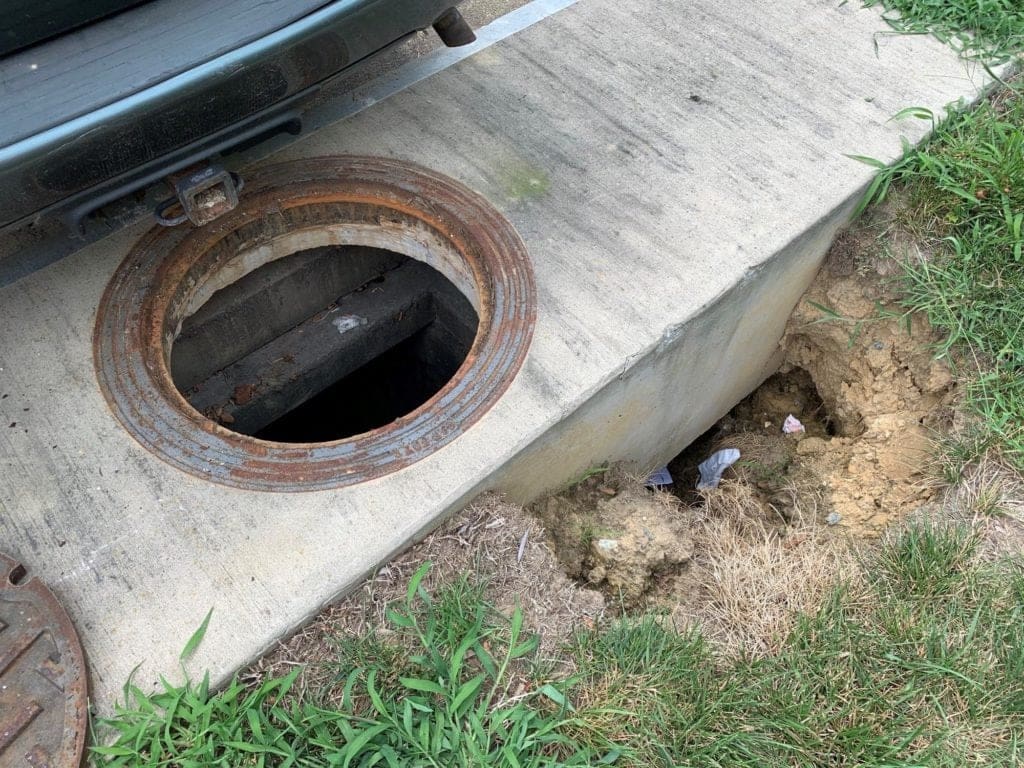 Sinkhole forming along a manhole