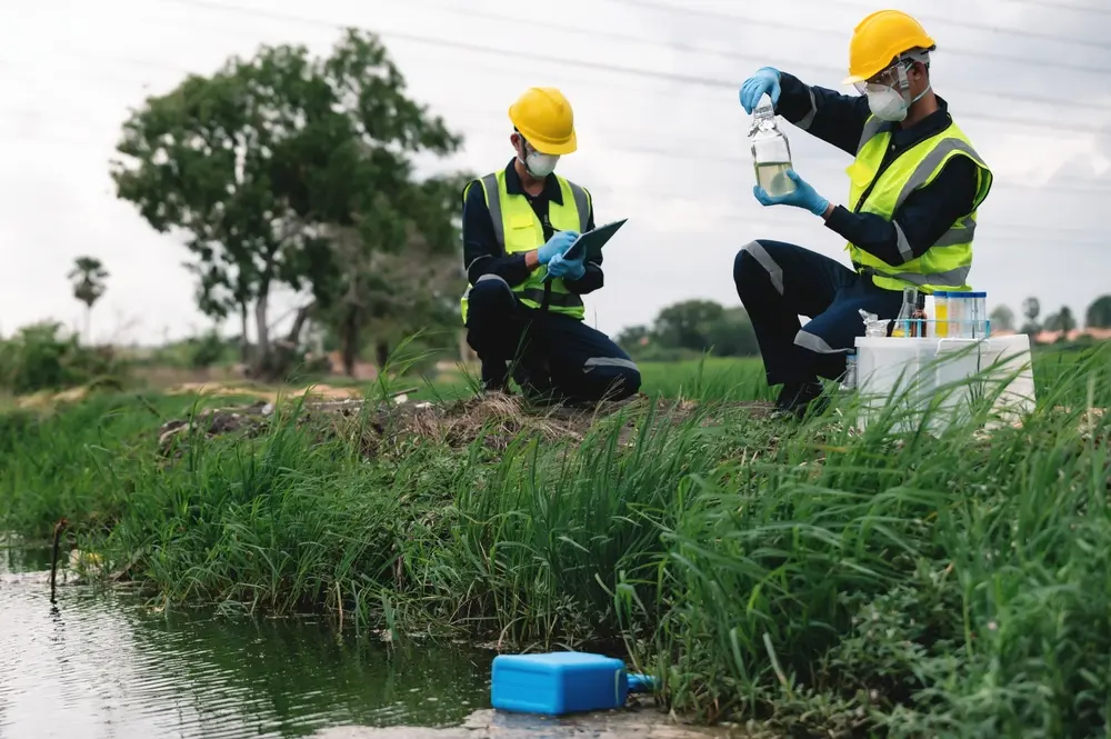 environmental engineers inspect water quality and take water sample notes