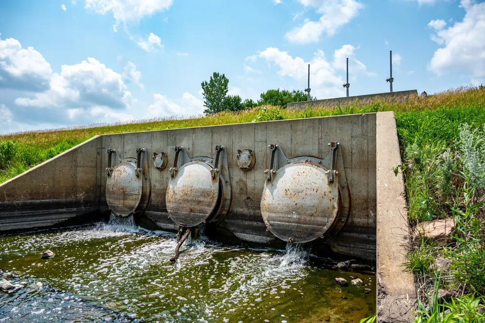 Heavy metal flood control gate discharging into a waterbody