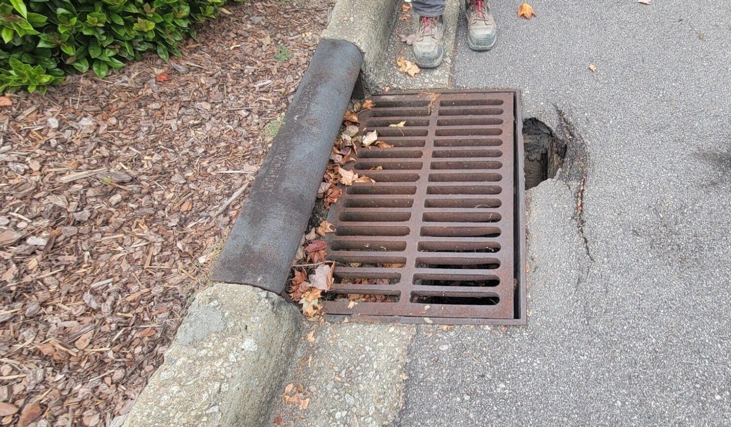 Stormwater Management for Commercial Markets - AQUALIS aging sewer grate on a curb